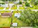 Community aerial view pointing to a single Gathering home, with lush green trees and neighboring houses at 2726 Victory Palm Dr, Edgewater, FL 32141