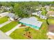 Aerial view of the property showcasing its well-maintained lawn, mature trees, and proximity to neighboring houses at 2726 Victory Palm Dr, Edgewater, FL 32141