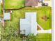 Overhead shot of property boundary, revealing home's layout, generous lawn, detached garage and tree coverage at 2726 Victory Palm Dr, Edgewater, FL 32141