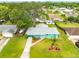 Birds eye view of a well kept house, a long driveway, lush greenery, and a detached garage at 2726 Victory Palm Dr, Edgewater, FL 32141