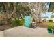 Backyard features hardscaping, trees with Spanish moss, and storage unit at 2726 Victory Palm Dr, Edgewater, FL 32141