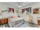 Cozy bedroom with unique curtains, hardwood-style flooring and a ceiling fan at 2726 Victory Palm Dr, Edgewater, FL 32141