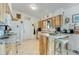 Kitchen with wooden cabinets, granite counters, a breakfast bar, and white appliances at 2726 Victory Palm Dr, Edgewater, FL 32141
