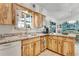 Kitchen area showcasing ample cabinet space, countertops, and a view into the dining room at 2726 Victory Palm Dr, Edgewater, FL 32141