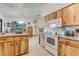 Bright kitchen featuring wood cabinets, white appliances and an open layout at 2726 Victory Palm Dr, Edgewater, FL 32141