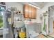Functional laundry room with a washer, dryer, storage cabinets, utility sink and access door at 2726 Victory Palm Dr, Edgewater, FL 32141