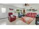 Cozy living room with tile flooring, comfortable seating, and bright natural light from the window at 2726 Victory Palm Dr, Edgewater, FL 32141