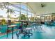 Enclosed porch with high ceilings, plenty of seating and dining, and many plants at 2726 Victory Palm Dr, Edgewater, FL 32141