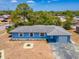 Aerial view of the blue home with a well-maintained yard and attached garage at 2802 English Dr, Deltona, FL 32738