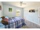 Cozy bedroom features neutral walls, a ceiling fan, a window, and closet with louvered doors at 2802 English Dr, Deltona, FL 32738