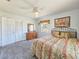 Cozy bedroom featuring neutral tones, plush carpeting, and a comfortable bed with decorative pillows at 2802 English Dr, Deltona, FL 32738