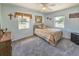 Bright bedroom features natural light, carpeted flooring, ceiling fan, and tasteful decor at 2802 English Dr, Deltona, FL 32738