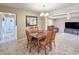 Dining area with wood table set, open to the living room, features tile floors and a chandelier at 2802 English Dr, Deltona, FL 32738