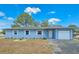 Inviting single-story home with a attached garage, and manicured lawn at 2802 English Dr, Deltona, FL 32738