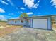 Quaint single-story home with a one-car garage, complemented by a well-kept lawn and clear blue skies at 2802 English Dr, Deltona, FL 32738