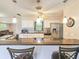 Bright kitchen featuring granite countertops, stainless steel appliances, mosaic backsplash, and breakfast bar seating at 2802 English Dr, Deltona, FL 32738