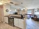Open floor plan showing eat-in kitchen with tile floors, a breakfast bar, and stainless steel appliances at 2802 English Dr, Deltona, FL 32738
