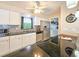 Renovated kitchen with stainless appliances, granite counters, a mosaic tile backsplash, and white cabinets at 2802 English Dr, Deltona, FL 32738