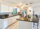Updated kitchen with white cabinets, granite counters, mosaic backsplash, stainless appliances, and bar seating at 2802 English Dr, Deltona, FL 32738