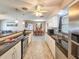 Open kitchen and dining area featuring granite countertops, stainless appliances, and tile floors throughout at 2802 English Dr, Deltona, FL 32738