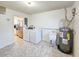 Spacious laundry room with washer, dryer, utility sink, water heater, and tile flooring at 2802 English Dr, Deltona, FL 32738