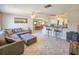 Open-concept living area featuring a breakfast bar with barstools, tiled floors, and a comfortable sectional couch at 2802 English Dr, Deltona, FL 32738