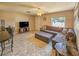 Inviting living room featuring tiled floors, a comfortable sectional couch, and plenty of natural light at 2802 English Dr, Deltona, FL 32738