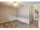 Neutral bedroom featuring wood floors and an open doorway at 306 Jefferson Ave, Port Orange, FL 32127