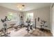Bright exercise room featuring multiple machines, hardwood floors, and natural light streaming through the windows at 306 Jefferson Ave, Port Orange, FL 32127