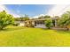 Charming home featuring a well-manicured lawn, mature trees, and a quaint white picket fence at 306 Jefferson Ave, Port Orange, FL 32127