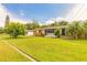 Charming single-story home featuring a well-manicured lawn and inviting front porch at 306 Jefferson Ave, Port Orange, FL 32127