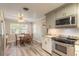 Cozy dining area adjacent to kitchen features a ceiling fan and natural light at 306 Jefferson Ave, Port Orange, FL 32127
