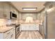 Modern kitchen boasts stainless steel appliances, granite countertops, and ample cabinet space at 306 Jefferson Ave, Port Orange, FL 32127