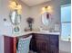 Bathroom area featuring dual sinks, oval mirrors, decorative accents, and ample counter space offers elegance and functionality at 31 E Sea Harbor, Ormond Beach, FL 32176