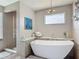 Modern bathroom with a standalone tub and a glass-enclosed shower, complemented by stylish lighting and decorative wall art at 31 E Sea Harbor, Ormond Beach, FL 32176