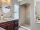 Bathroom featuring a modern vanity, oval mirror, a glass shower, and stylish fixtures create a bright and inviting space at 31 E Sea Harbor, Ormond Beach, FL 32176