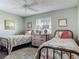 Inviting bedroom with two twin beds, ceiling fan, and natural light from the window at 31 E Sea Harbor, Ormond Beach, FL 32176