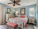 Cozy bedroom with tropical decor, including a palm tree picture and ceiling fan at 31 E Sea Harbor, Ormond Beach, FL 32176