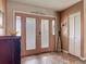 Warm foyer featuring neutral colors, a decorative rug, and a rustic 