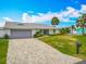 Charming exterior view highlighting the freshly painted house, palm trees, and a well-manicured lawn at 31 E Sea Harbor, Ormond Beach, FL 32176