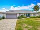 Exterior of house with nicely manicured lawn, plants and a brick driveway leading to the garage at 31 E Sea Harbor, Ormond Beach, FL 32176