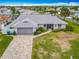 Inviting front of home with a brick driveway, lush lawn, and a charming seahorse decoration at 31 E Sea Harbor, Ormond Beach, FL 32176