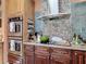 Well-equipped kitchen with stainless steel appliances, tile backsplash and custom cabinets at 31 E Sea Harbor, Ormond Beach, FL 32176