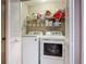 Laundry room with washer and dryer, storage shelves, and organized laundry supplies offers efficiency and convenience at 31 E Sea Harbor, Ormond Beach, FL 32176