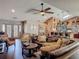 Comfortable living area featuring a large sectional sofa, tile floors, and a decorative ceiling fan at 31 E Sea Harbor, Ormond Beach, FL 32176