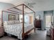 Relaxing main bedroom featuring a four-poster bed and tiled floors at 31 E Sea Harbor, Ormond Beach, FL 32176