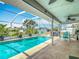 Relaxing screened pool with seating and tropical plants provides a refreshing outdoor escape at 31 E Sea Harbor, Ormond Beach, FL 32176
