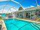 A sparkling pool within a screened enclosure, surrounded by lush landscaping and comfortable seating offers relaxation and recreation at 31 E Sea Harbor, Ormond Beach, FL 32176