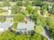 Aerial view highlighting the property's placement on a tree-lined street, close to a golf course at 315 Sweet Bay Ave, New Smyrna Beach, FL 32168