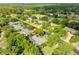 Aerial view highlighting the property's placement on a tree-lined street, close to a golf course at 315 Sweet Bay Ave, New Smyrna Beach, FL 32168